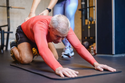 A senior man assessing how recovered he feels after training